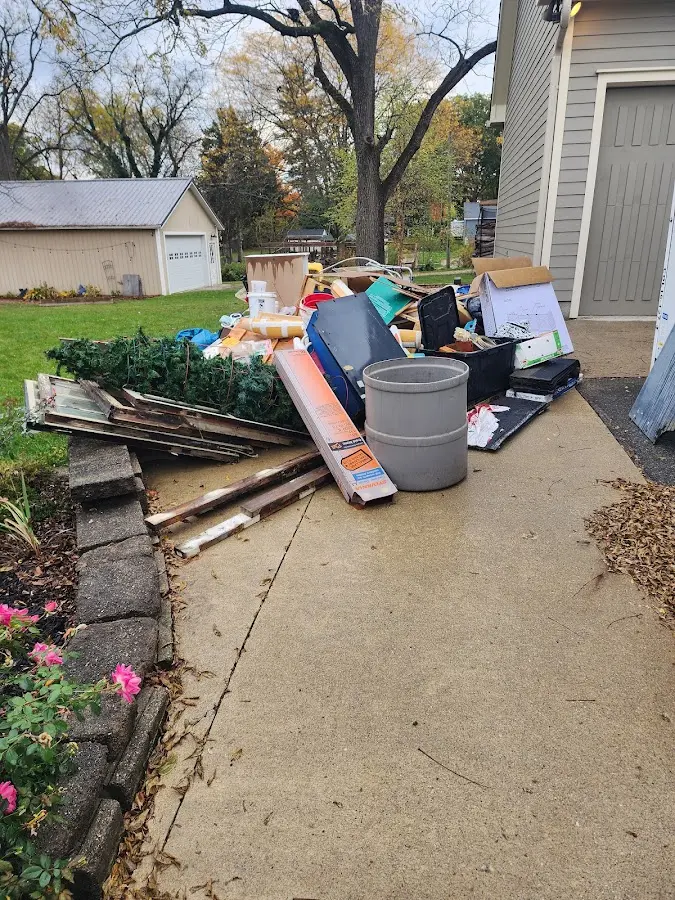 Dumpster being loaded with debris for Estate Cleanout Dumpster Rental in Algoma